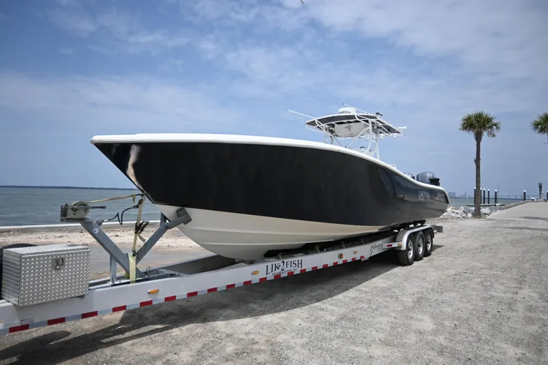 The Image of 2004 Yellowfin 36 boat on trailer by the shore. - 0