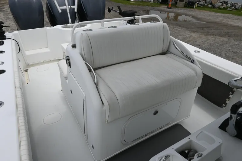 Slide: The Image of 2004 Yellowfin 36 boat with cushioned seating and storage compartment. - 13