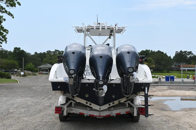 Slide: The Image of 2004 Yellowfin 36 boat with triple outboard engines on a trailer. - 4