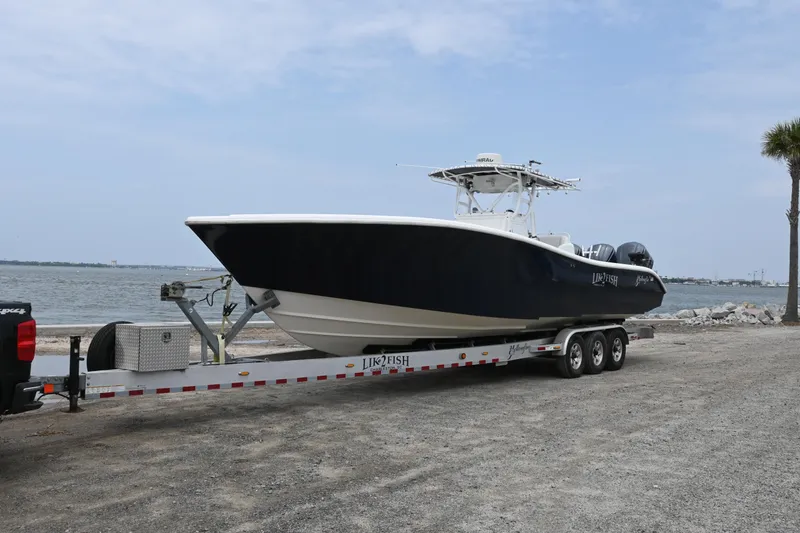 Slide: The Image of 2004 Yellowfin 36 boat on a trailer by the waterfront. - 5