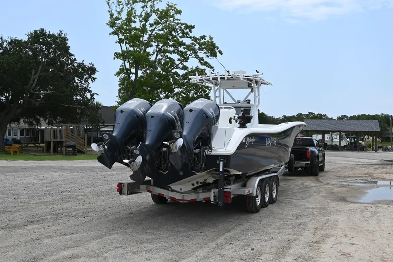 Slide: The Image of 2004 Yellowfin 36 boat on trailer with triple outboard engines. - 6