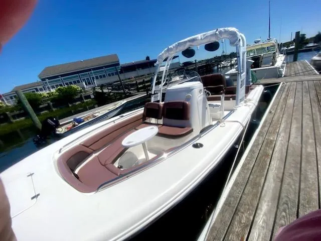 Slide: The Image of 2017 Tidewater 230 LXF boat docked at a marina on a sunny day. - 6