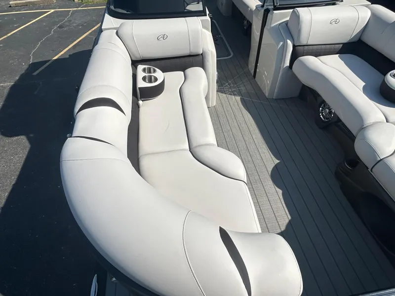 Slide: The Image of 2023 Avalon 2585 EL boat interior with plush seating and cup holders. - 11
