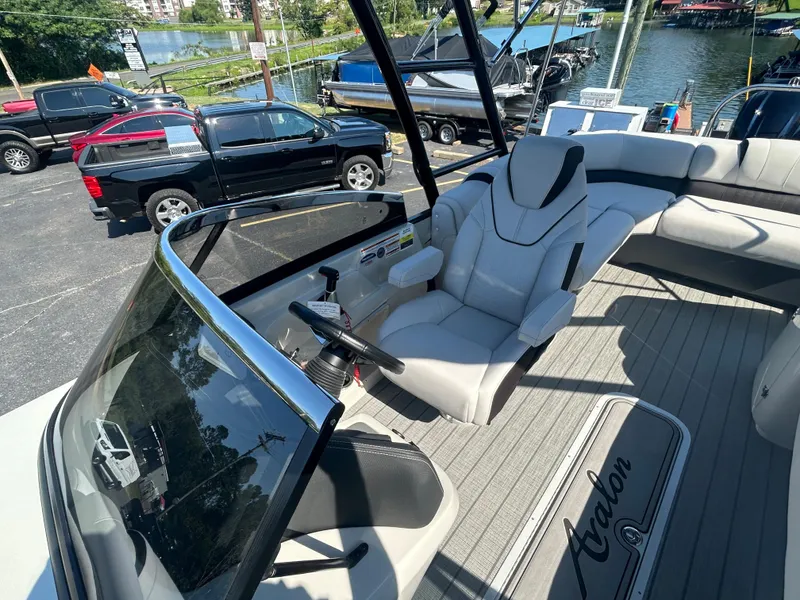 Slide: The Image of 2023 Avalon 2585 EL pontoon boat interior with captain's chair and spacious seating. - 16