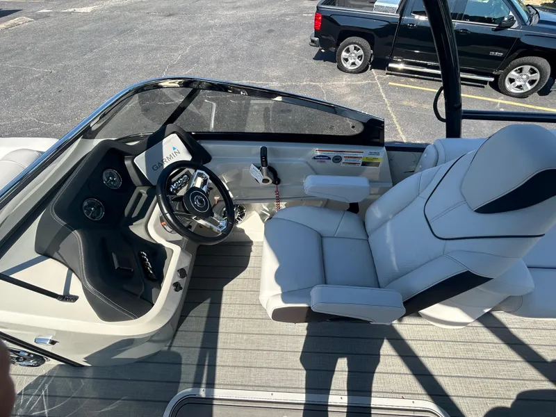 Slide: The Image of 2023 Avalon 2585 EL boat interior with steering wheel and captain's chair. - 17
