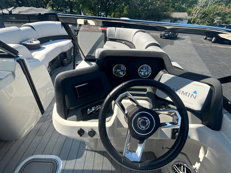 Slide: The Image of 2023 Avalon 2585 EL boat interior with steering wheel and seating area. - 18