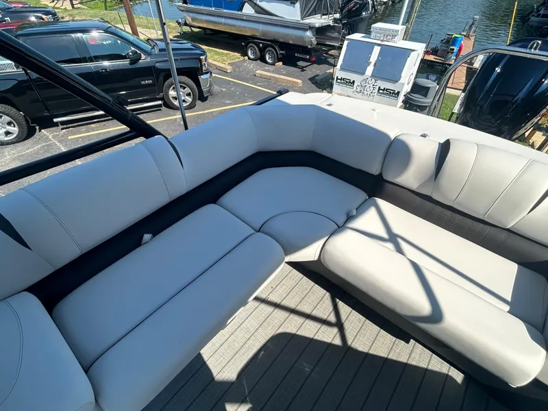 Slide: The Image of 2023 Avalon 2585 EL boat with spacious seating area at a marina. - 23