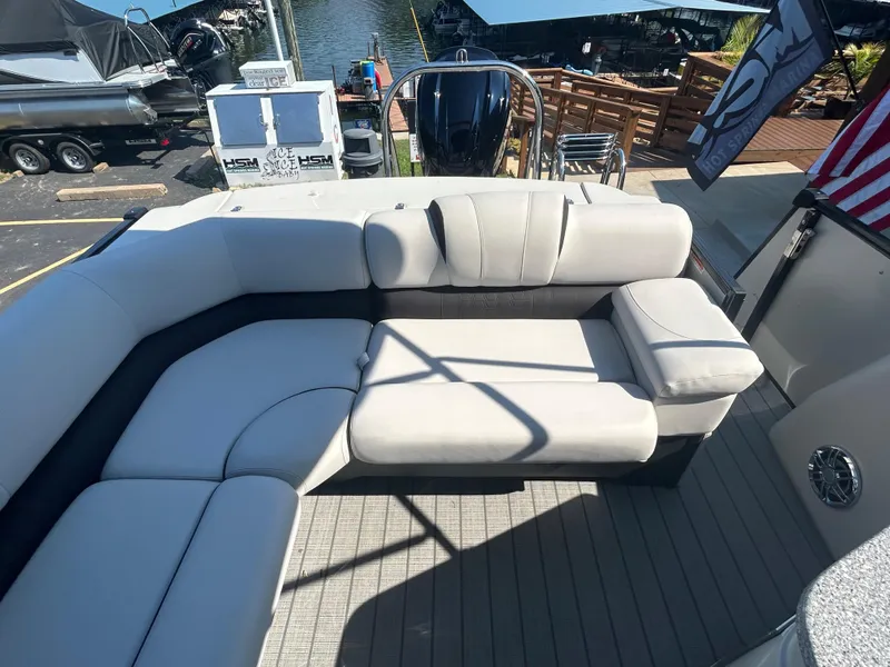 Slide: The Image of 2023 Avalon 2585 EL boat with luxurious seating at a marina. - 24