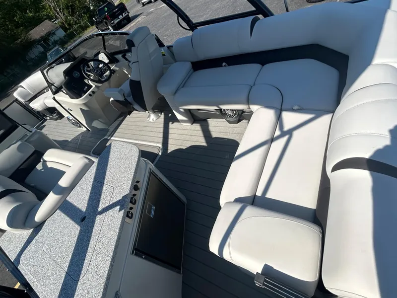 Slide: The Image of 2023 Avalon 2585 EL boat interior with luxurious seating and modern dashboard. - 25