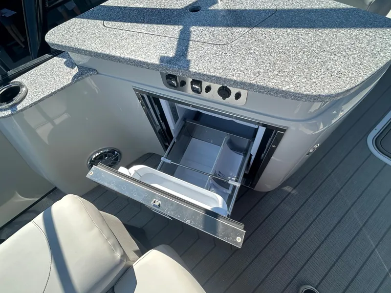 Slide: The Image of 2023 Avalon 2585 EL boat interior with open storage drawer and granite countertop. - 27