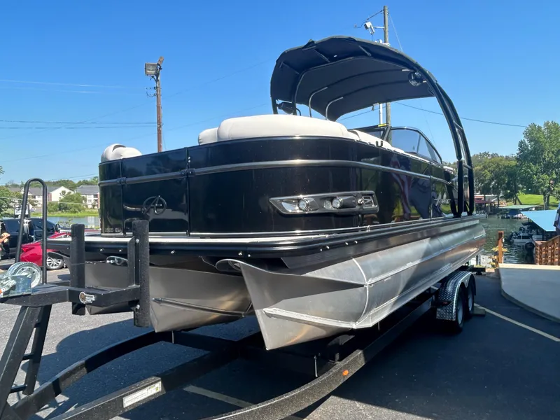 Slide: The Image of 2023 Avalon 2585 EL pontoon boat on a trailer in a parking lot. - 3