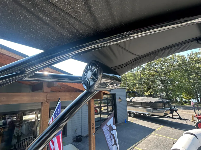 Slide: The Image of 2023 Avalon 2585 EL pontoon boat with sleek black canopy and modern design. - 34