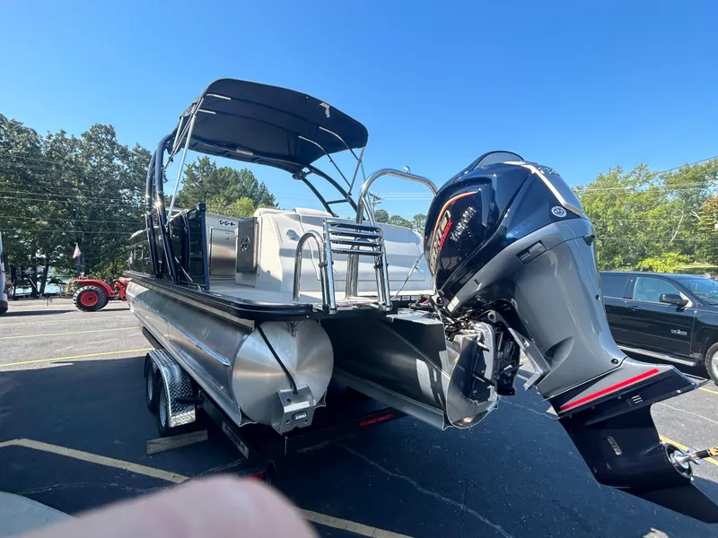 Slide: The Image of 2023 Avalon 2585 EL pontoon boat with outboard motor in parking lot. - 5