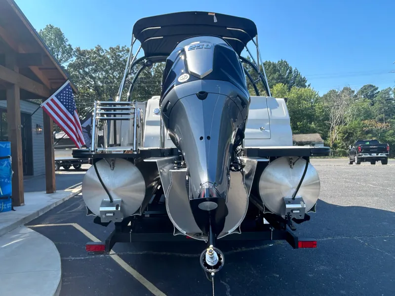 Slide: The Image of 2023 Avalon 2585 EL pontoon boat with powerful outboard motor, parked on a trailer. - 7