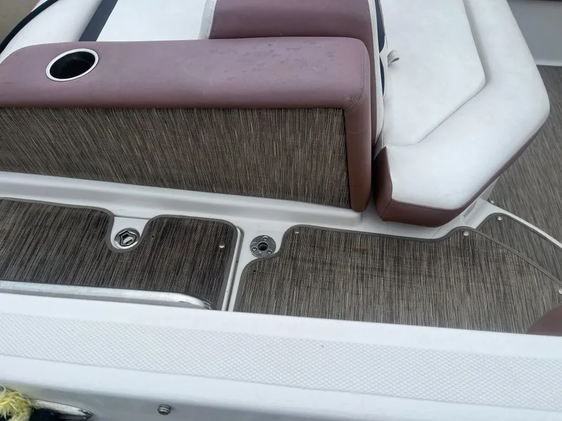 Slide: The Image of 2017 Four Winns 24 Bow Rider boat interior with brown and white seating. - 5