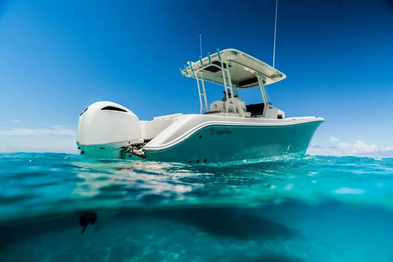 The Image of 2024 Edgewater 325CC boat on clear blue water. - 1