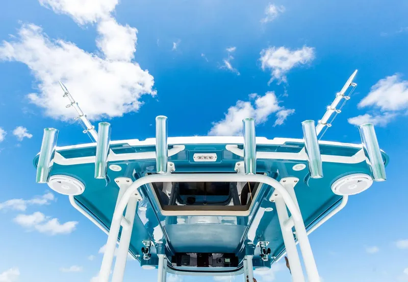 Slide: The Image of 2024 Edgewater 325CC boat against a blue sky with clouds. - 10