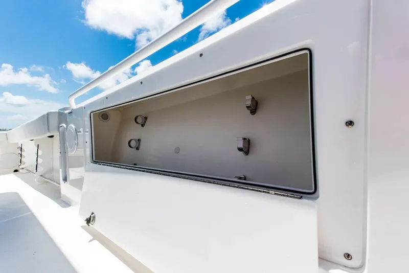 Slide: The Image of 2024 Edgewater 325CC boat storage compartment with blue sky background. - 11