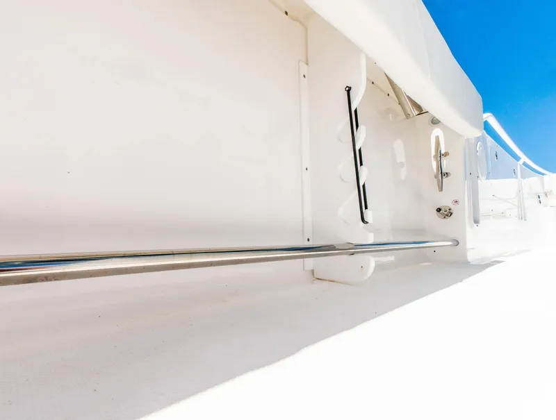 Slide: The Image of 2024 Edgewater 325CC boat interior with stainless steel railing and white finish. - 12