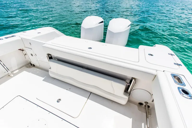 Slide: The Image of 2024 Edgewater 325CC boat with dual outboard motors on clear water. - 15