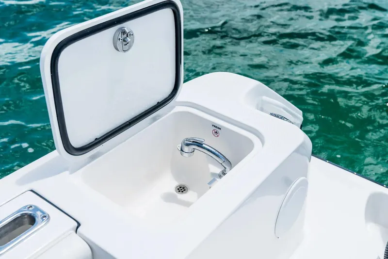Slide: The Image of Edgewater 325CC 2024 boat sink and storage compartment. - 17
