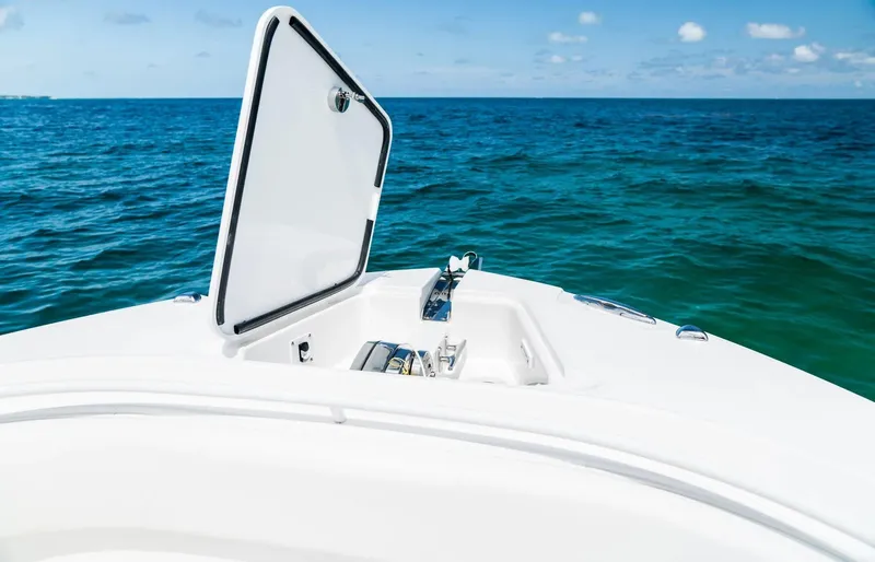 Slide: The Image of 2024 Edgewater 325CC boat with open hatch on the ocean. - 4
