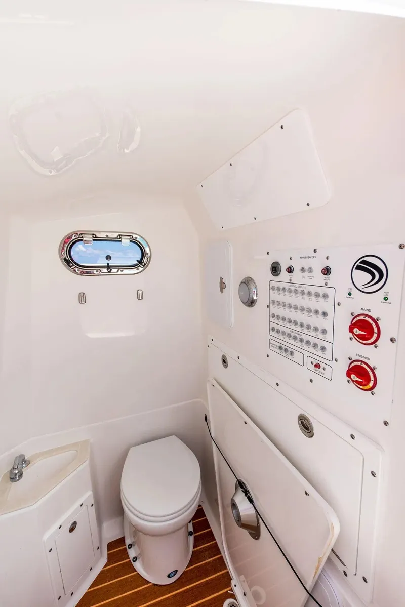 Slide: The Image of 2024 Edgewater 325CC boat interior with toilet, sink, and control panel. - 6