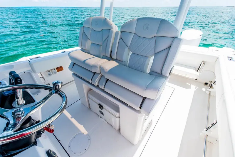 Slide: The Image of 2024 Edgewater 325CC boat interior with luxurious seating and ocean view. - 8