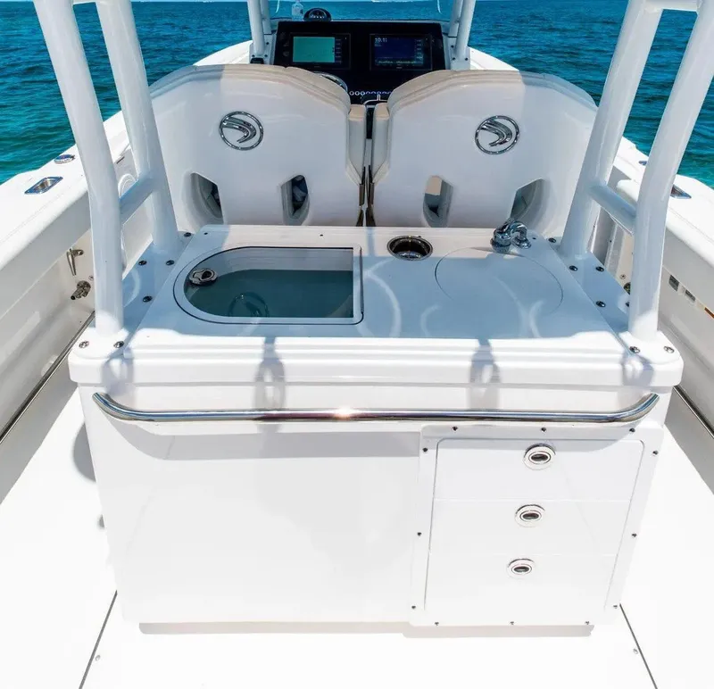 Slide: The Image of 2024 Edgewater 325CC boat interior with helm station and storage compartments. - 9