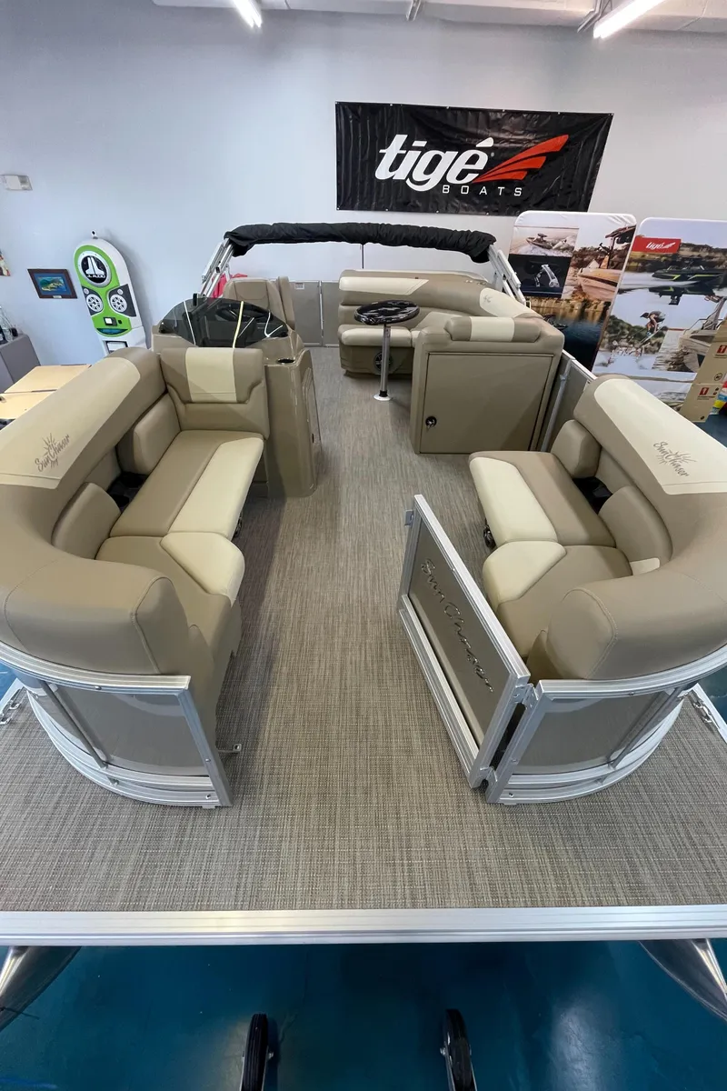 Slide: The Image of 2024 SunChaser Geneva Cruise 20 pontoon boat interior with beige seating. - 10