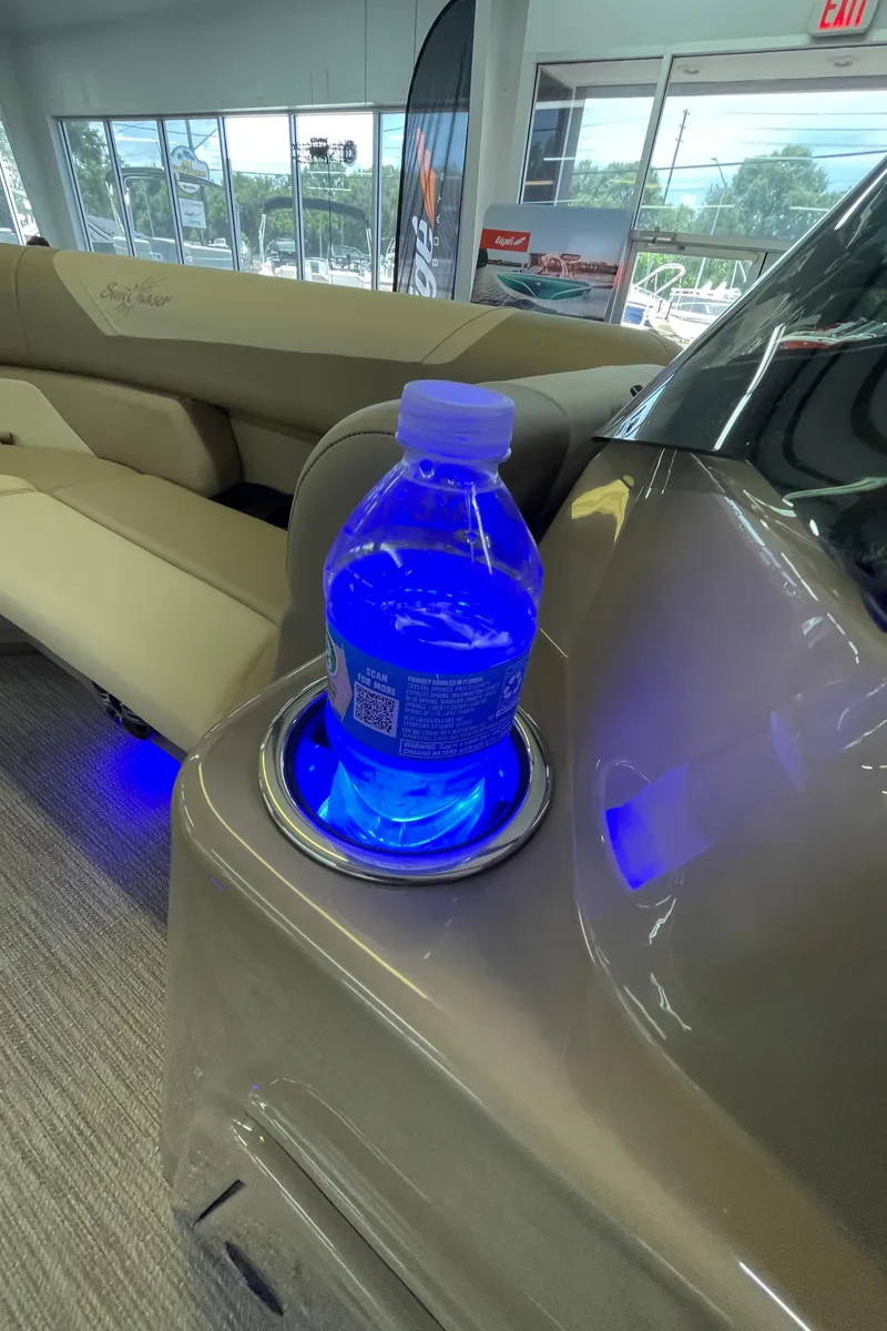 Slide: The Image of 2024 SunChaser Geneva Cruise 20 boat with illuminated cup holder and water bottle. - 12