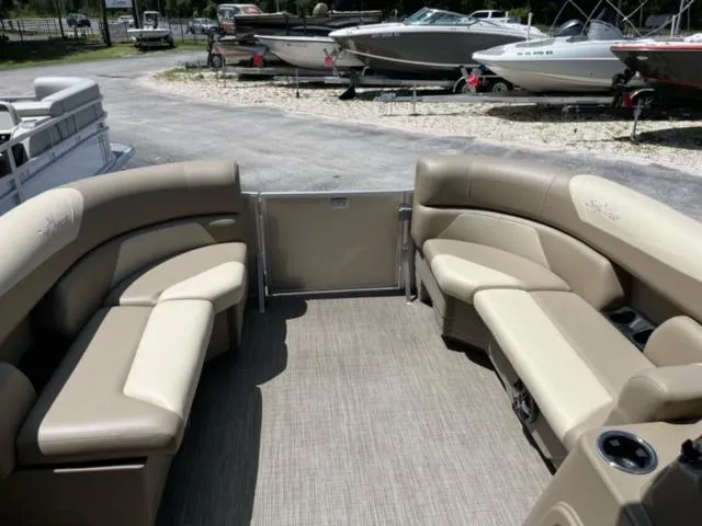 Slide: The Image of 2024 SunChaser Geneva Cruise 20 pontoon boat interior with beige seating. - 15