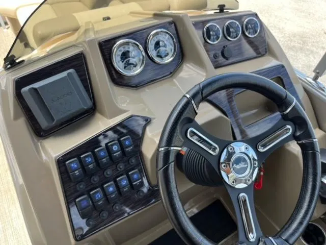 Slide: The Image of 2024 SunChaser Geneva Cruise 20 dashboard with steering wheel and control panel. - 16