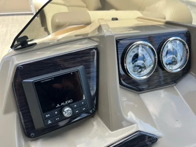 Slide: The Image of 2024 SunChaser Geneva Cruise 20 dashboard with JL Audio system and gauges. - 22