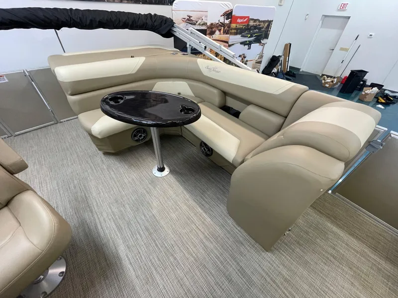 Slide: The Image of 2024 SunChaser Geneva Cruise 20 boat interior with beige seating and a black table. - 4