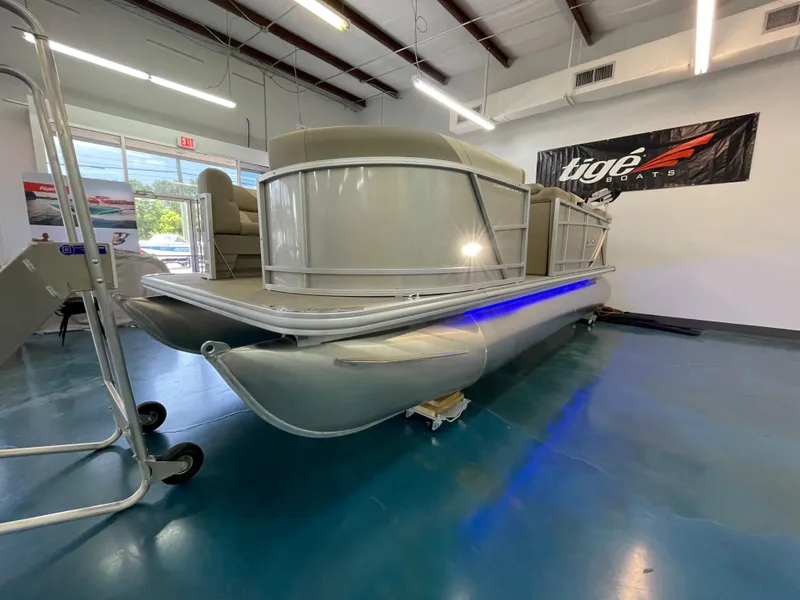 Slide: The Image of 2024 SunChaser Geneva Cruise 20 pontoon boat displayed indoors. - 6