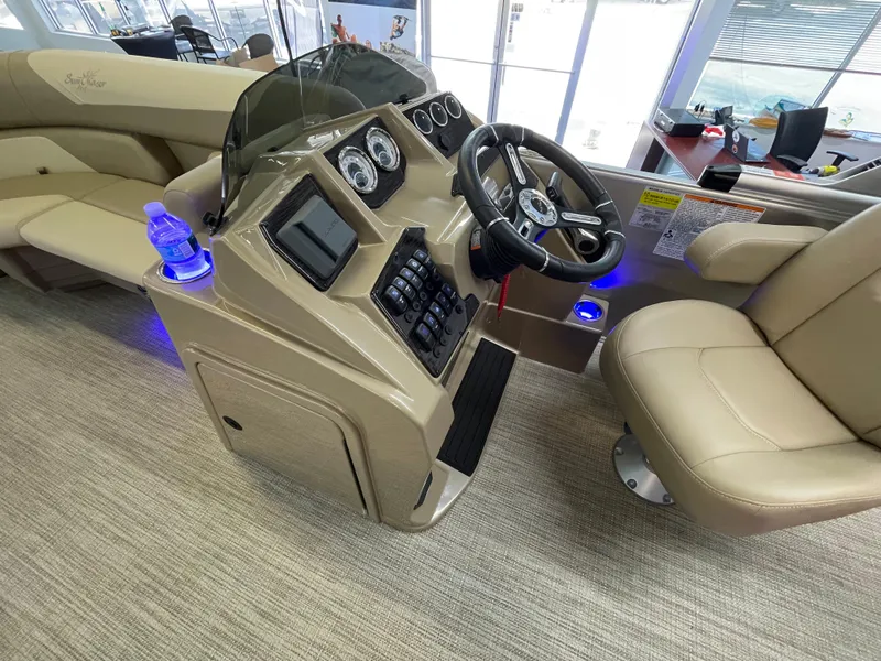 Slide: The Image of 2024 SunChaser Geneva Cruise 20 boat interior with steering console and beige seating. - 9