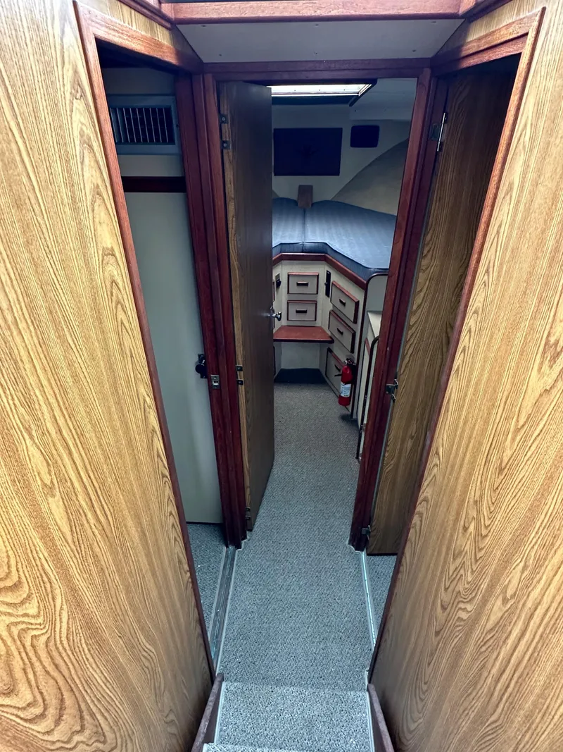 Slide: The Image of Interior cabin of a 1981 Bertram 38III Convertible boat with wood paneling and cozy sleeping area. - 11