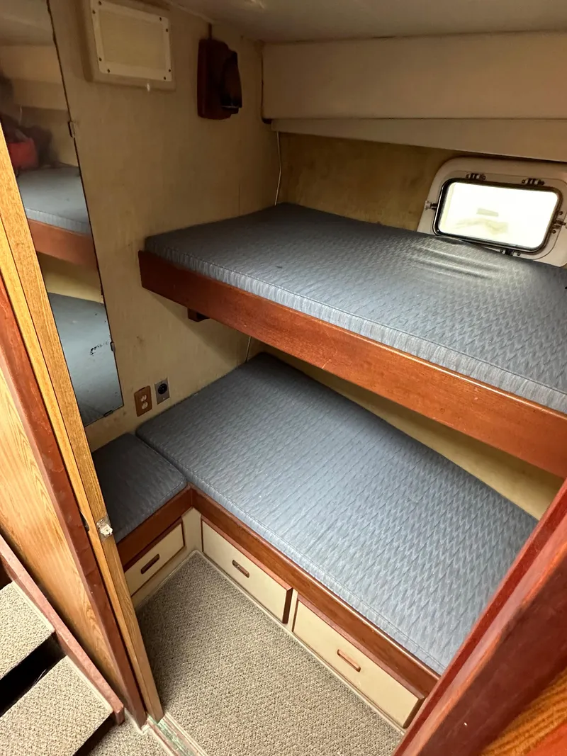 Slide: The Image of 1981 Bertram 38III Convertible cabin with bunk beds and storage. - 13