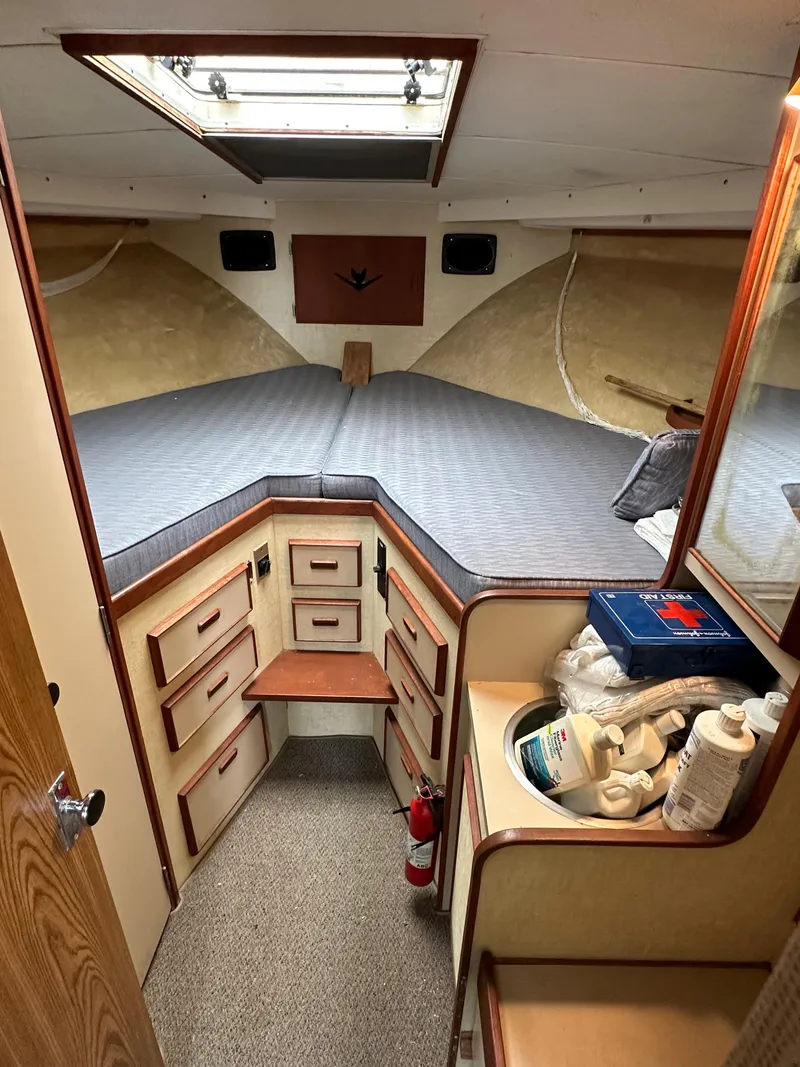 Slide: The Image of 1981 Bertram 38III Convertible cabin interior with storage drawers and a bed. - 14