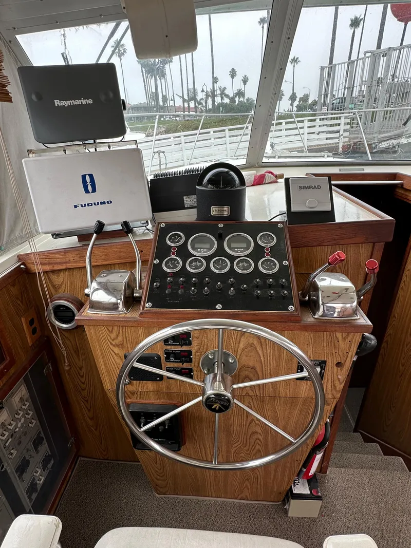 Slide: The Image of 1981 Bertram 38III Convertible boat helm with navigation equipment and steering wheel. - 17
