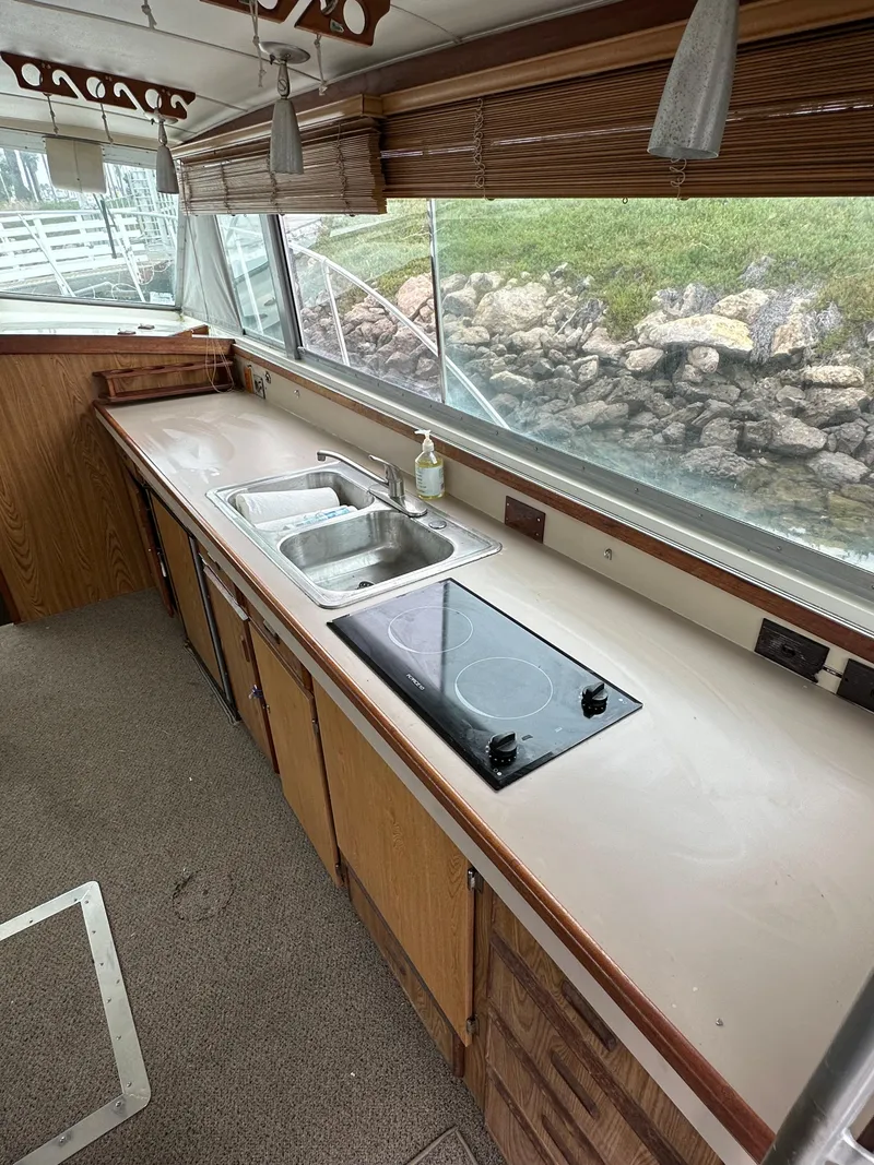 Slide: The Image of 1981 Bertram 38III Convertible yacht kitchen with sink and stovetop. - 8