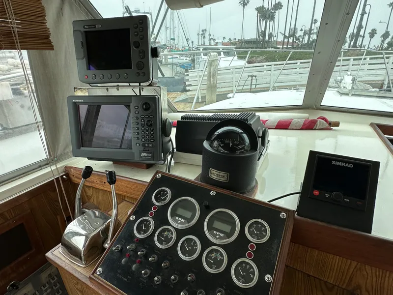 Slide: The Image of 1981 Bertram 38III Convertible helm with navigation equipment and controls. - 9