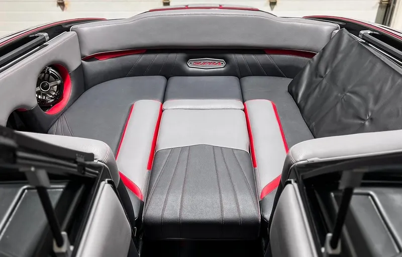 Slide: The Image of 2023 Supra SA boat interior with red and gray leather seating. - 12