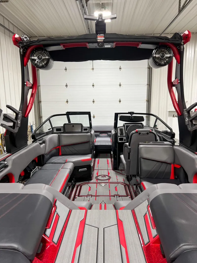 Slide: The Image of Interior of 2023 Supra SA boat with red and gray seating and advanced audio system. - 6