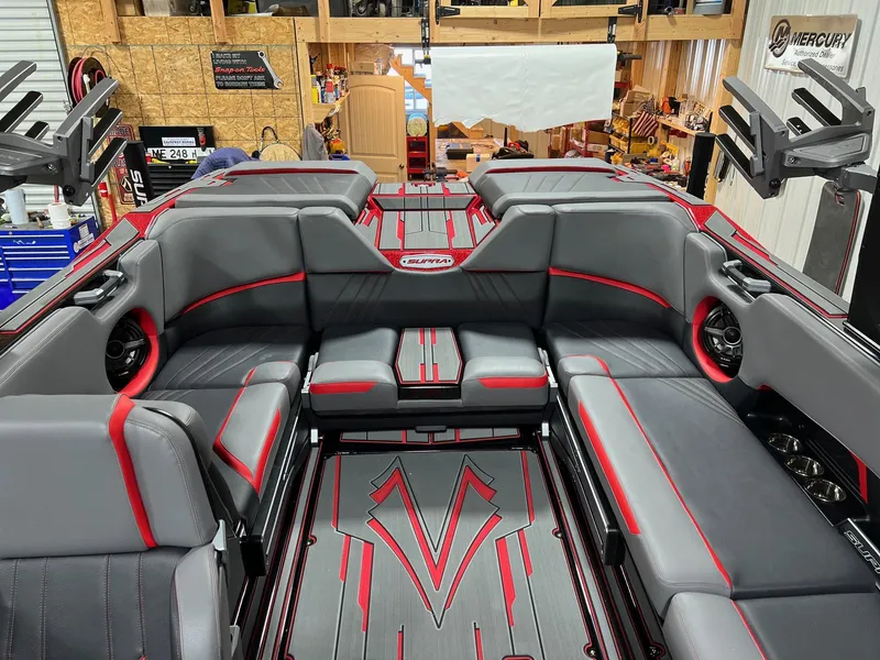 Slide: The Image of 2023 Supra SA boat interior with gray and red upholstery in a workshop. - 8