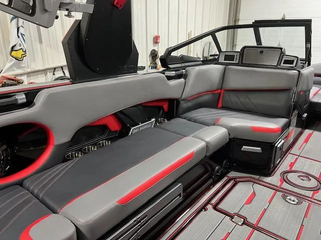 Slide: The Image of 2023 Supra SA boat interior with gray and red seating. - 9