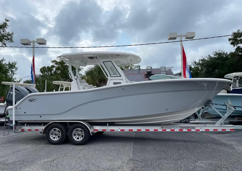 The Image of 2024 Sea Fox 288 Commander boat on a trailer, displayed outdoors under cloudy skies. - 0