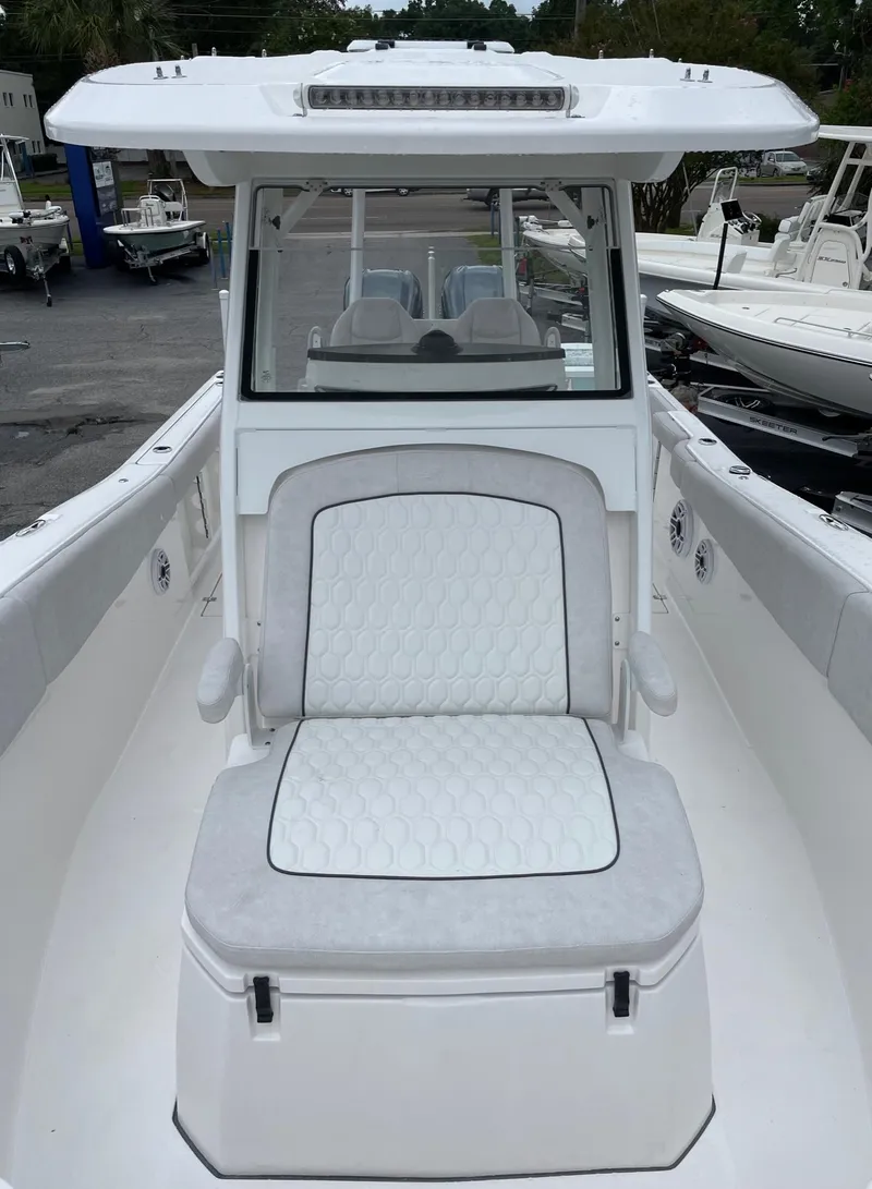 Slide: The Image of 2024 Sea Fox 288 Commander boat with white seating and sleek design. - 13
