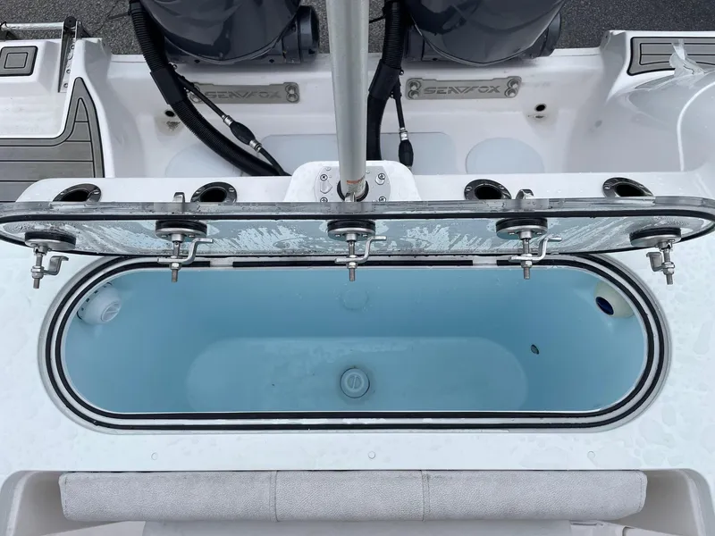 Slide: The Image of Livewell on 2024 Sea Fox 288 Commander boat, featuring rod holders and clean design. - 18